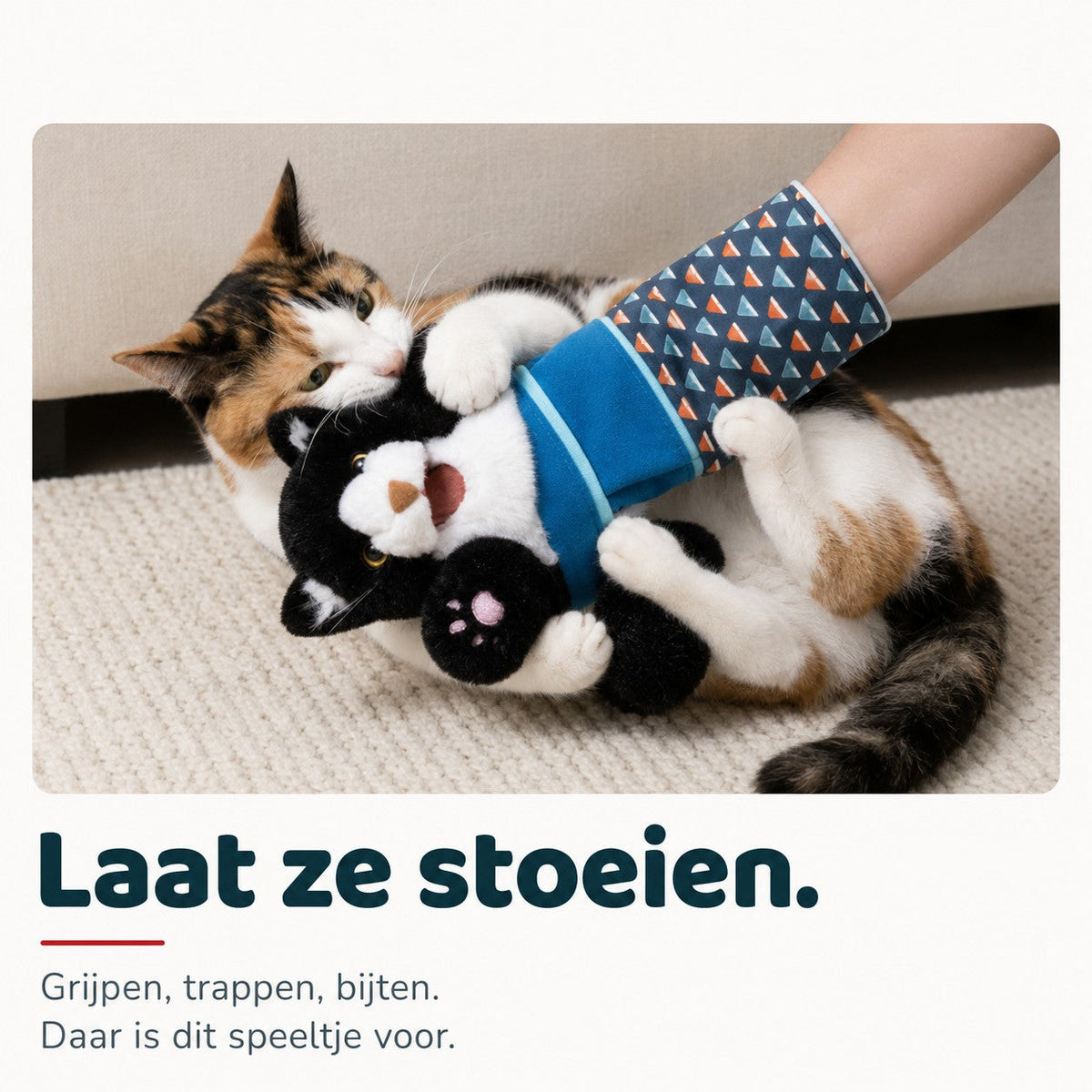 Calico cat wrestling the Brawlcat puppet on a rug. Dutch text: let them tussle.